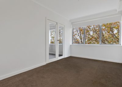 Photo of a room in a house in St Kilda, VIC before new was carpet installed by Investa Projects.