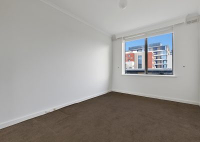 Photo of a room in a house in St Kilda, VIC before new was carpet installed by Investa Projects.
